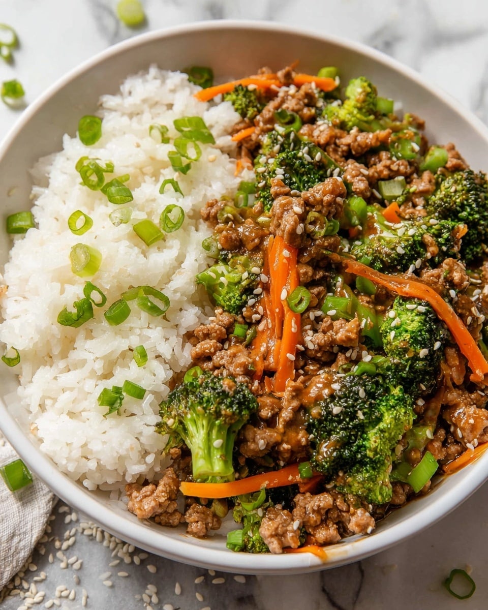A white bowl filled with a dish that has two main layers: on the left side, fluffy white rice topped with scattered chopped green onions, and on the right side, a mix of cooked ground meat, bright green broccoli florets, thin bright orange carrot strips, and more chopped green onions, all coated in a shiny brown sauce and sprinkled with light-colored sesame seeds. The bowl sits on a white marbled surface with some loose sesame seeds and green onion pieces around it. photo taken with an iphone --ar 4:5 --v 7