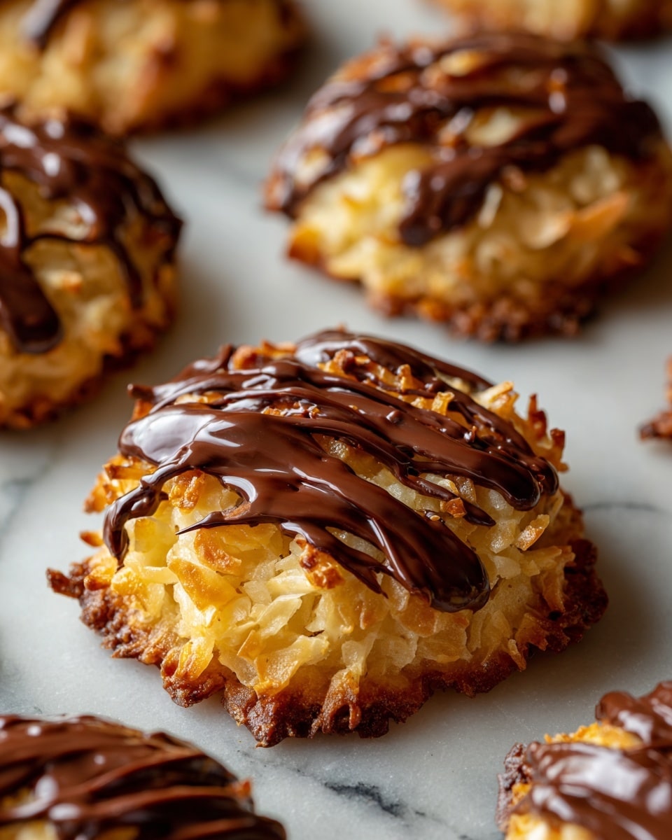 The image shows a close-up of round cookies on a white marbled surface, each with three distinct layers. The bottom layer is a golden brown, slightly crispy cookie base with a rough edge. The middle layer is a pale, shredded coconut topping that looks moist and slightly caramelized. The top layer is a dark, glossy drizzle of chocolate, unevenly spread in thin streams across the coconut layer, adding a rich contrast in color and texture. The cookies are arranged closely, with some blurred in the background, creating a sense of depth and focus on the front cookie. photo taken with an iphone --ar 4:5 --v 7