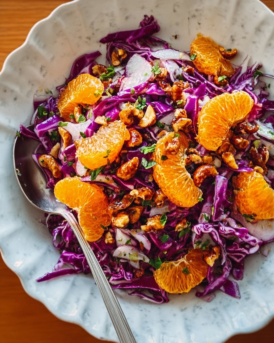 A salad is shown in a white fluted bowl on a white marbled surface. Starting from the bottom layer, there are thin strips of bright purple cabbage evenly spread out. On top of this lies a layer of white, thinly sliced onions, scattered throughout. Bright orange tangerine segments are placed over the onions, adding a juicy and fresh look. Small roasted nuts, deep golden brown with a slightly shiny texture, are sprinkled over the whole bowl. Bits of green herbs are scattered among the layers, adding a fresh contrast against the other colors. A metal spoon rests on the edge of the bowl, catching some light. Photo taken with an iphone --ar 4:5 --v 7